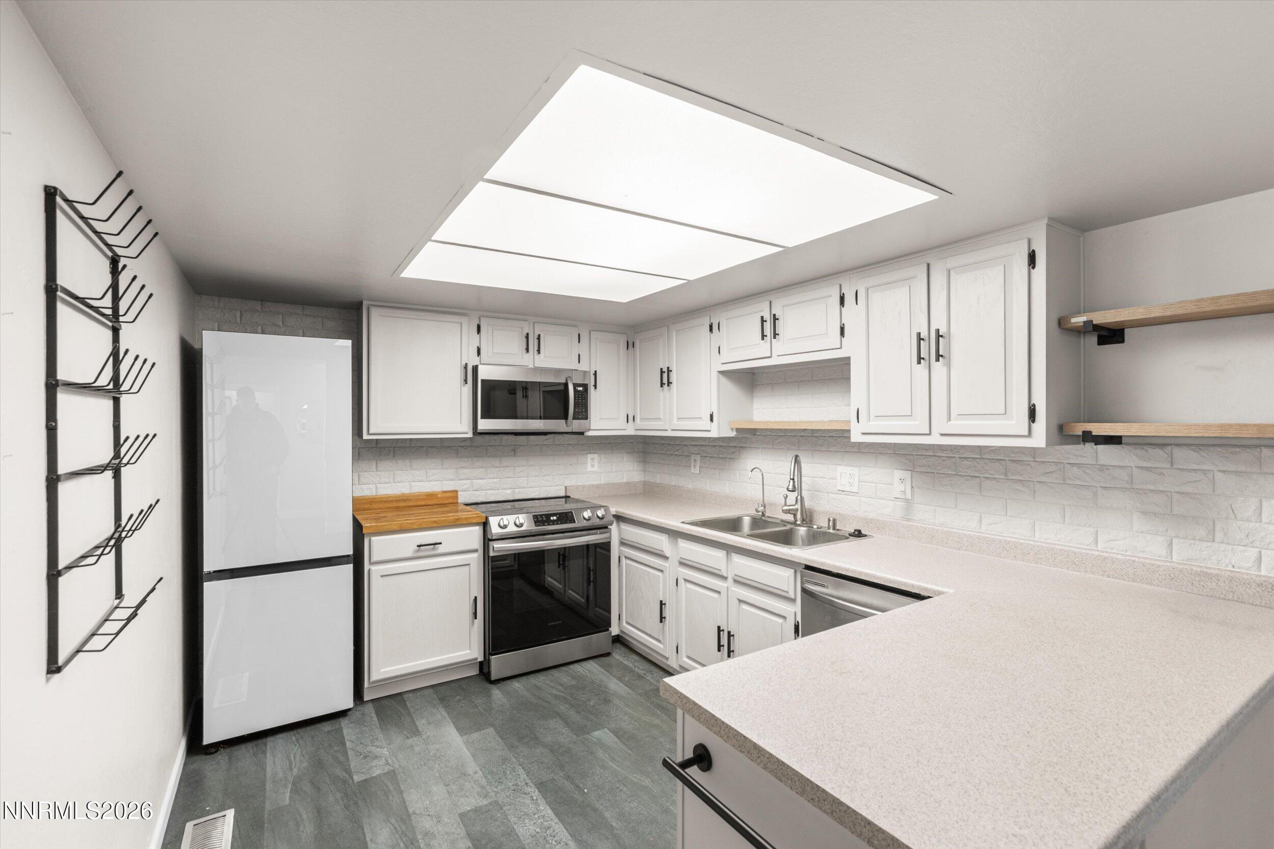 2300 Dickerson Road, Unit 51 Reno, NV 89503 - Photo 7 of 46 a kitchen with stainless steel appliances granite countertop a sink stove and refrigerator