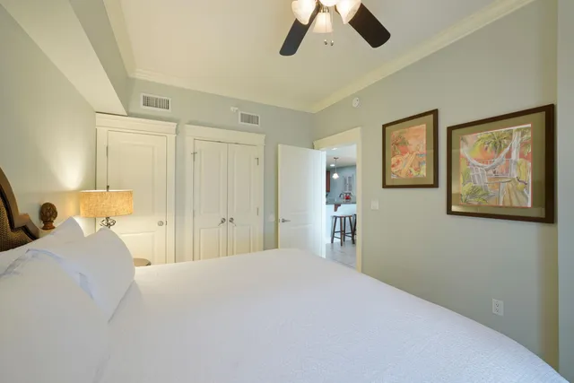 a bedroom with a large bed and a chandelier