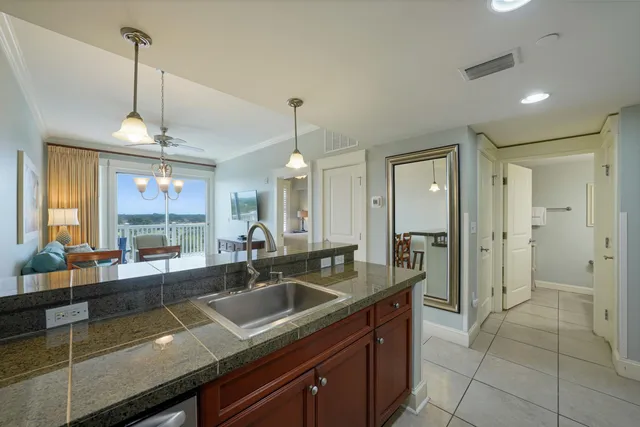 a kitchen with granite countertop a sink and a counter top space