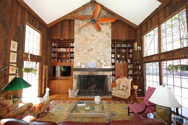 47 Walnut Road Weston, MA 02493 - Photo 11 of 25 a living room with furniture a fireplace and a floor to ceiling window
