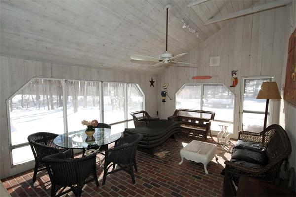 47 Walnut Road Weston, MA 02493 - Photo 10 of 25 a living room with couches a dining table and chairs with outer view