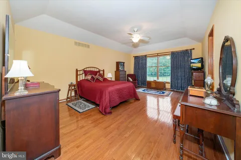 a bed room with a bed and a chair