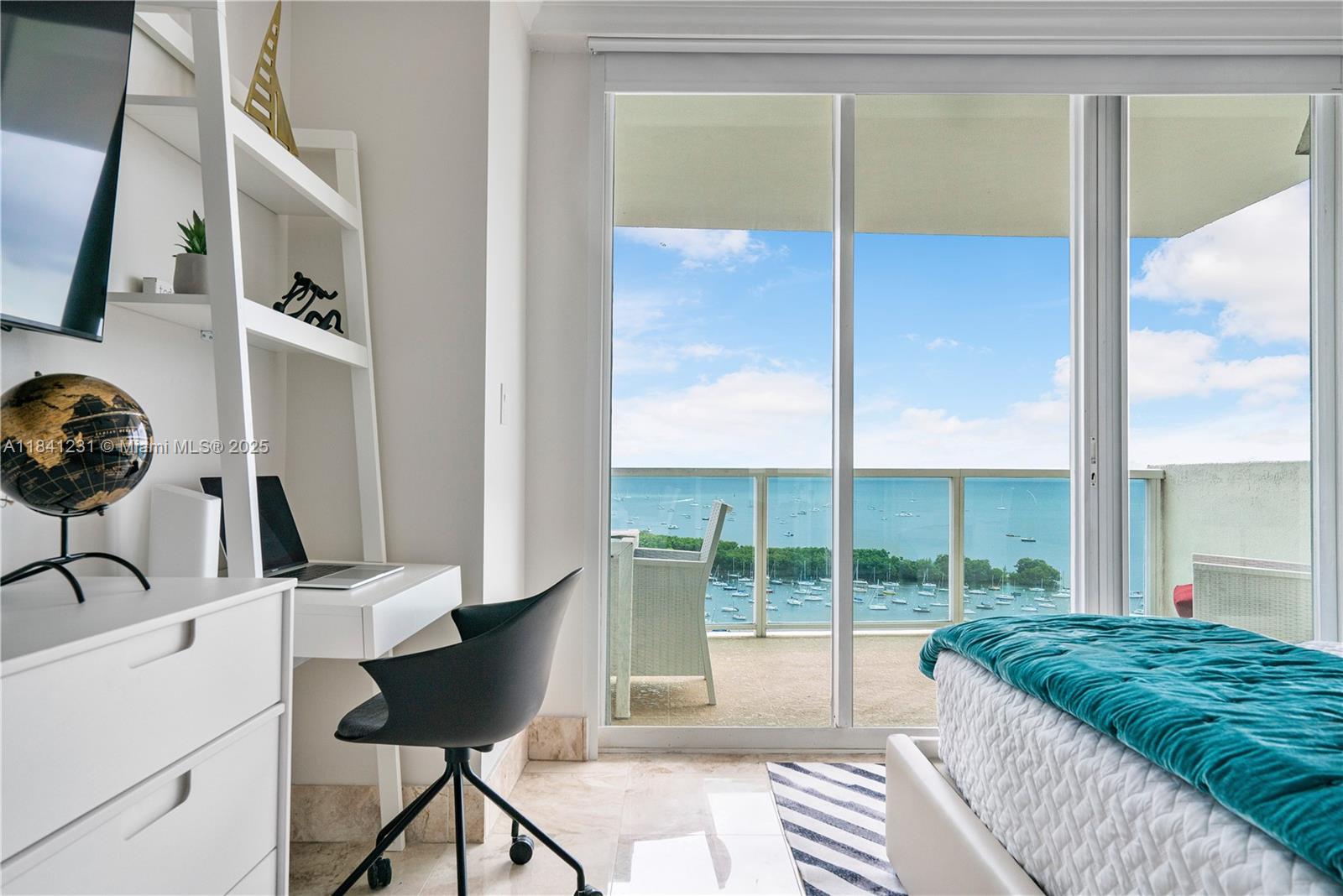 2889 McFarlane Road, Unit 1801 Miami, FL 33133 - Photo 20 of 38 a living room with a couch and a floor to ceiling window