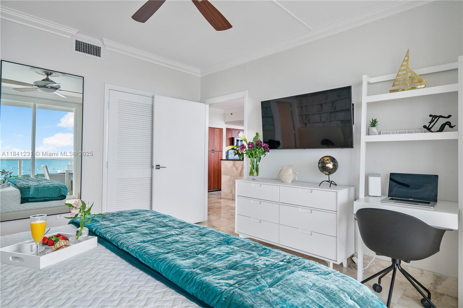 2889 McFarlane Road, Unit 1801 Miami, FL 33133 - Photo 22 of 38 a living room with furniture and a flat screen tv