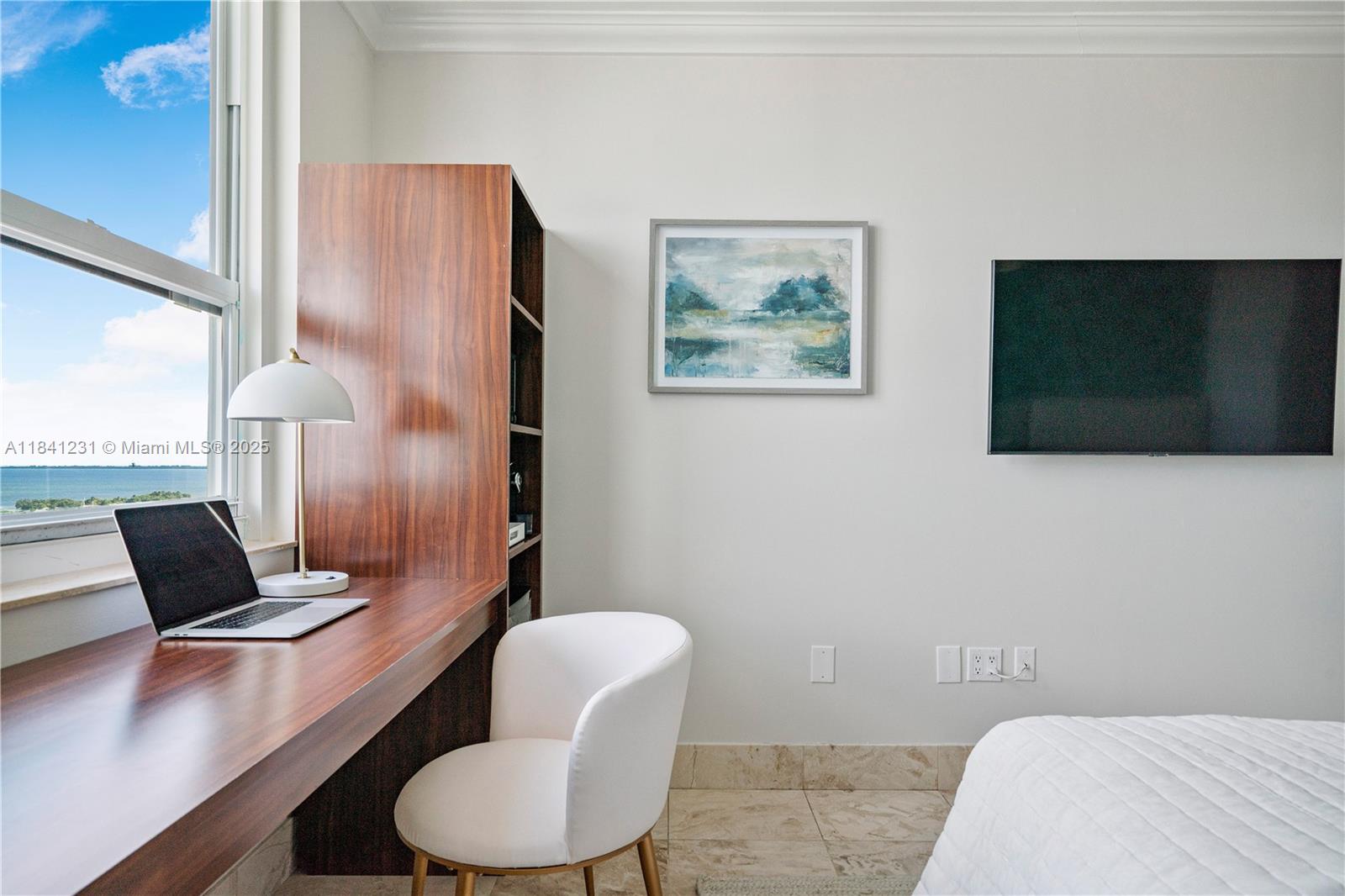 2889 McFarlane Road, Unit 1801 Miami, FL 33133 - Photo 25 of 38 a living room with furniture and a flat screen tv