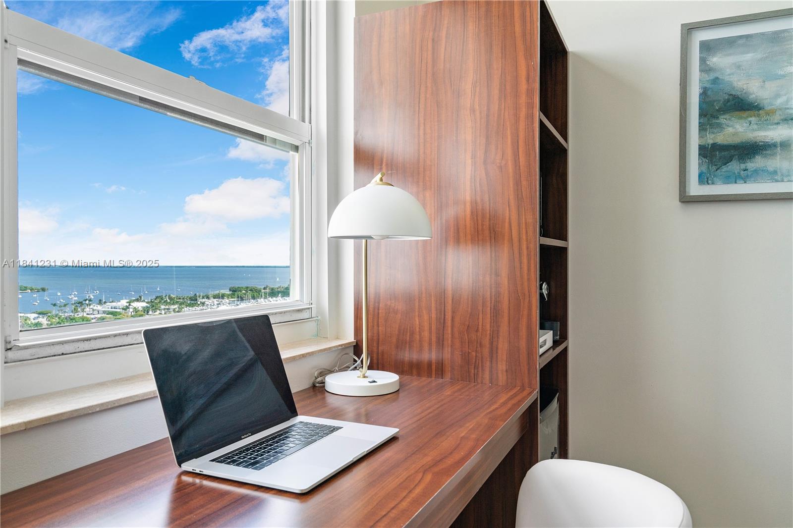 2889 McFarlane Road, Unit 1801 Miami, FL 33133 - Photo 29 of 38 a living room with furniture and a floor to ceiling window