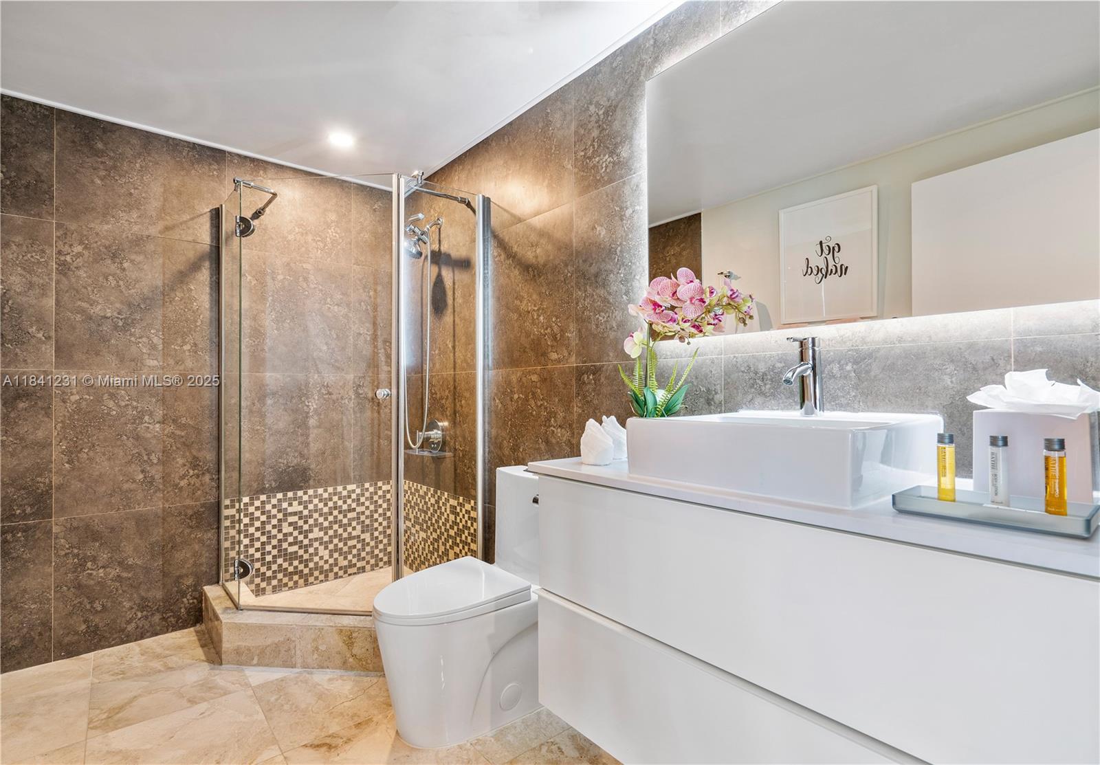 2889 McFarlane Road, Unit 1801 Miami, FL 33133 - Photo 37 of 38 a bathroom with a sink toilet and shower