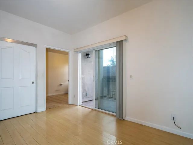 an empty room with wooden floor and closet