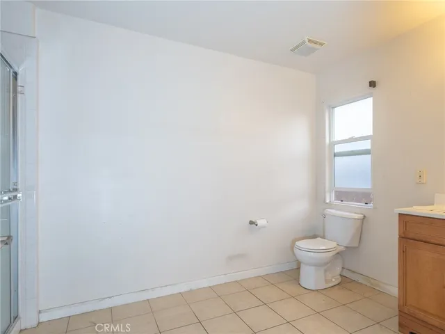 a white toilet sitting next to a bathroom sink