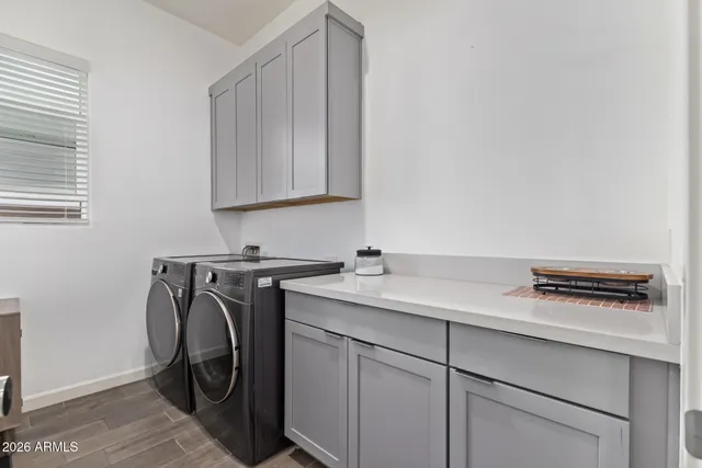a utility room with sink dryer and washer