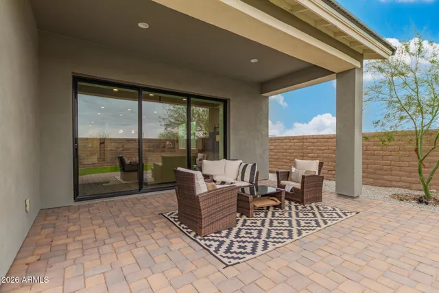 a living room with furniture and a floor to ceiling window