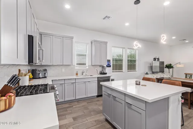 a kitchen with a sink stove and cabinets