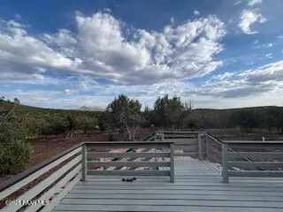 a view of a dry yard with wooden fence