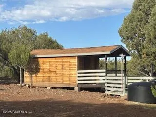 a kitchen with stainless steel appliances granite countertop a refrigerator a stove and a dining table with wooden floor