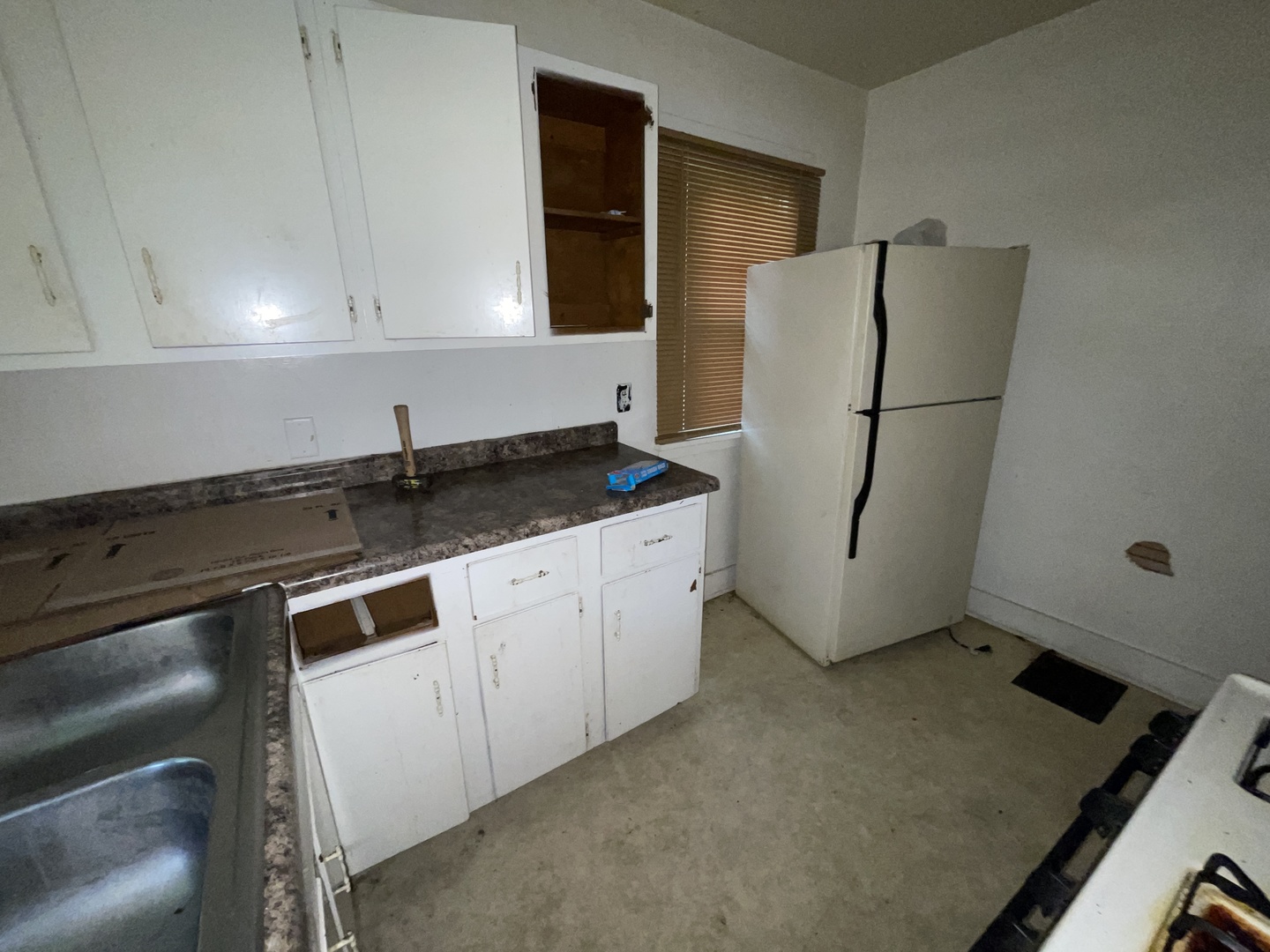 552 West Center Street Decatur, IL 62526 - Photo 24 of 26 a kitchen with a sink cabinets and a refrigerator