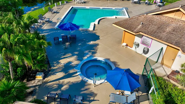 an aerial view of a house with garden space pool seating area and yard