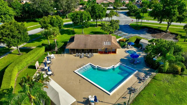 an aerial view of residential houses with outdoor space and trees