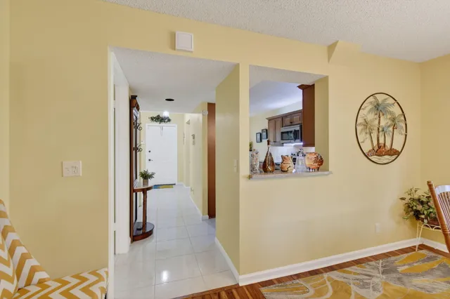 a kitchen with stainless steel appliances granite countertop a stove a sink dishwasher and a microwave oven with white cabinets