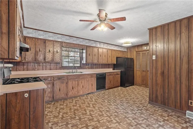 a kitchen with a stove a sink and a refrigerator