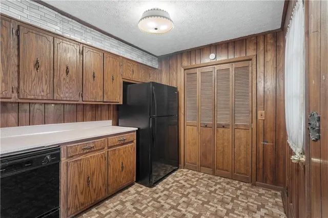 a kitchen with a refrigerator and cabinets