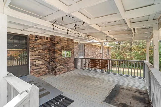 a view of a porch with wooden floor