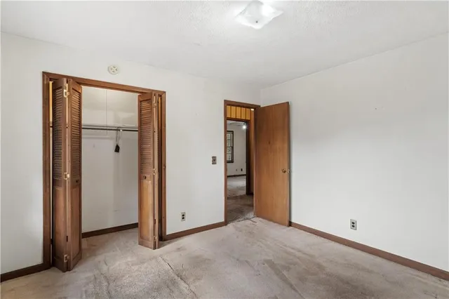 an empty room with closet area