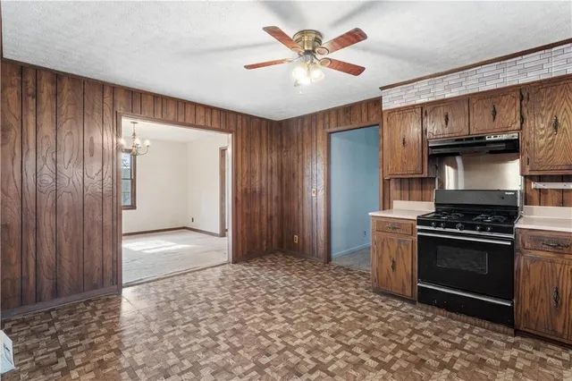 a kitchen with stainless steel appliances granite countertop a stove and a refrigerator