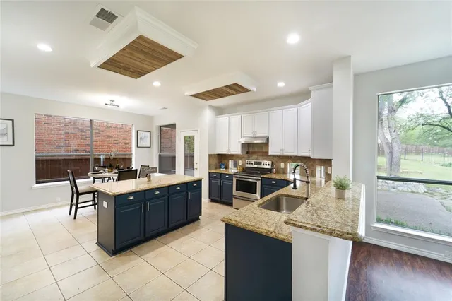 a kitchen with stainless steel appliances granite countertop a stove oven and a refrigerator