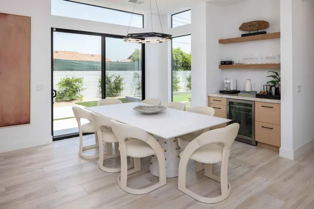 a kitchen with a table chairs stove and cabinets