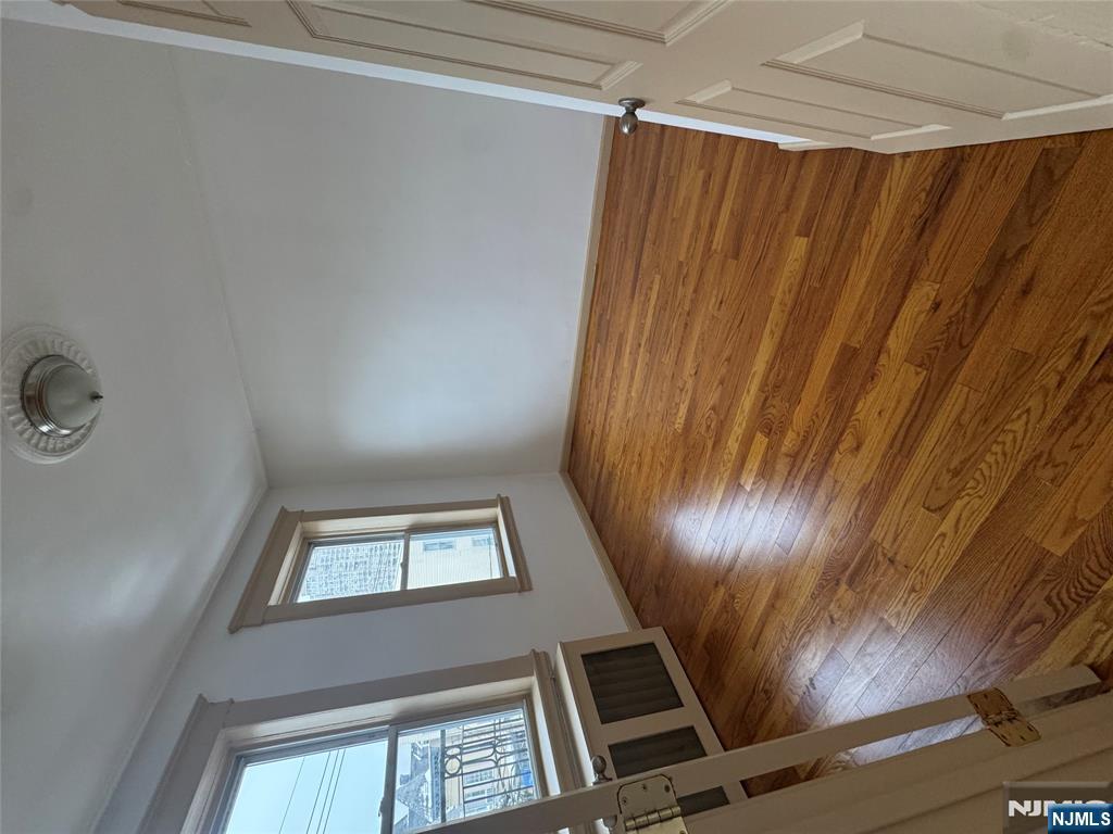 43 66th Street West New York, NJ 07093 - Photo 4 of 8 wooden floor in an empty room with a window