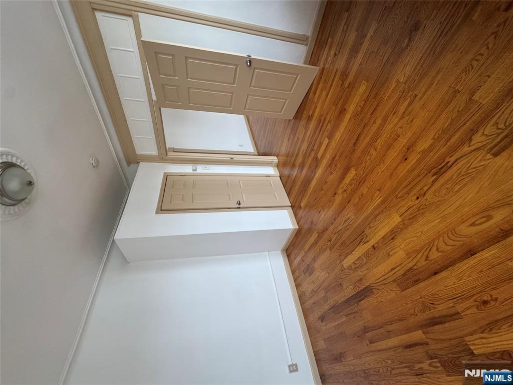 43 66th Street West New York, NJ 07093 - Photo 5 of 8 a view of empty room with wooden floor and fan