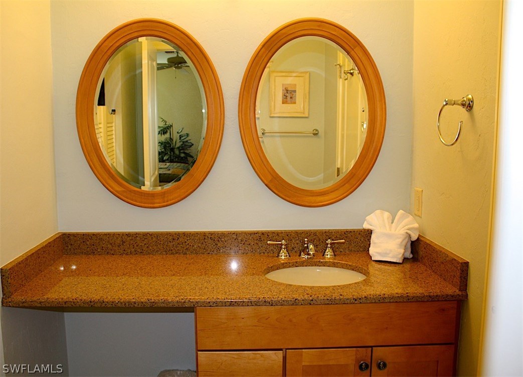 5117 Sea Bell Road, Unit F108 Sanibel, FL 33957 - Photo 12 of 17 a bathroom with a sink and a mirror