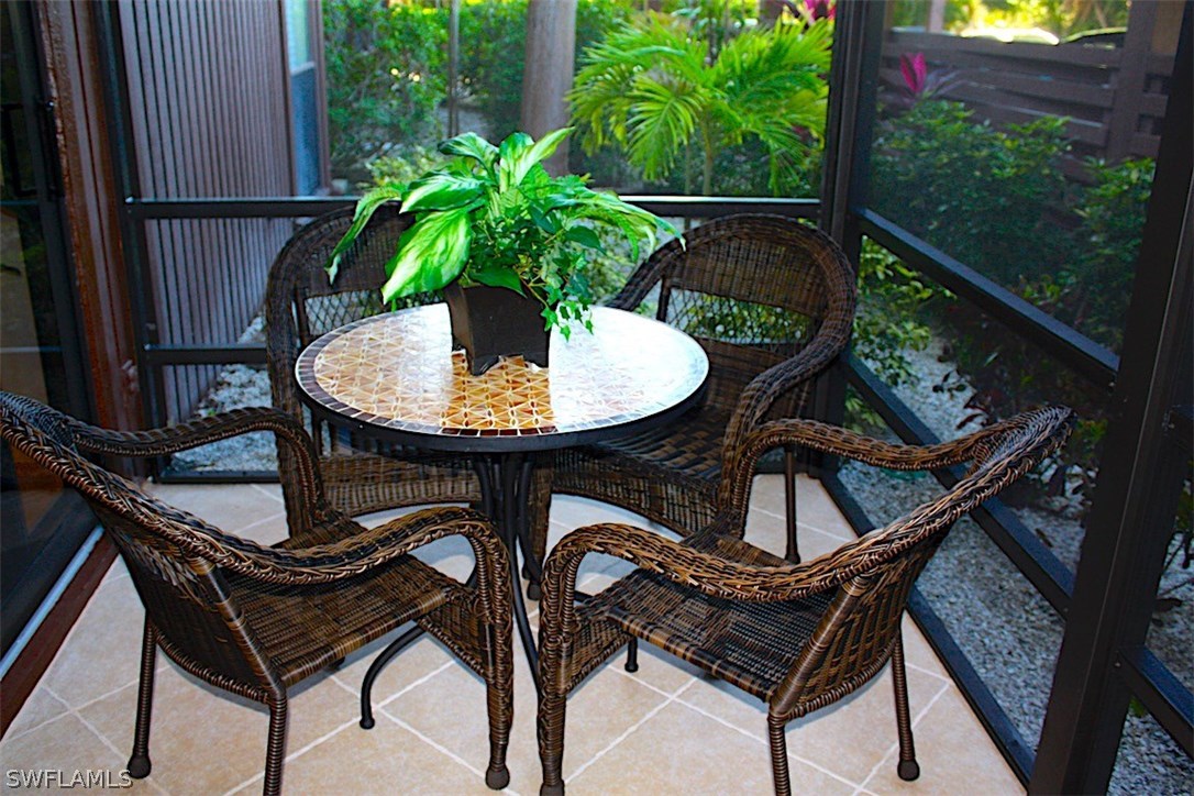 5117 Sea Bell Road, Unit F108 Sanibel, FL 33957 - Photo 14 of 17 a backyard of a house with table and chairs
