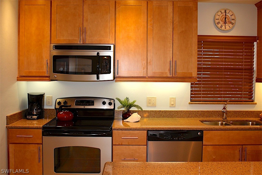5117 Sea Bell Road, Unit F108 Sanibel, FL 33957 - Photo 5 of 17 a kitchen with a stove and a microwave