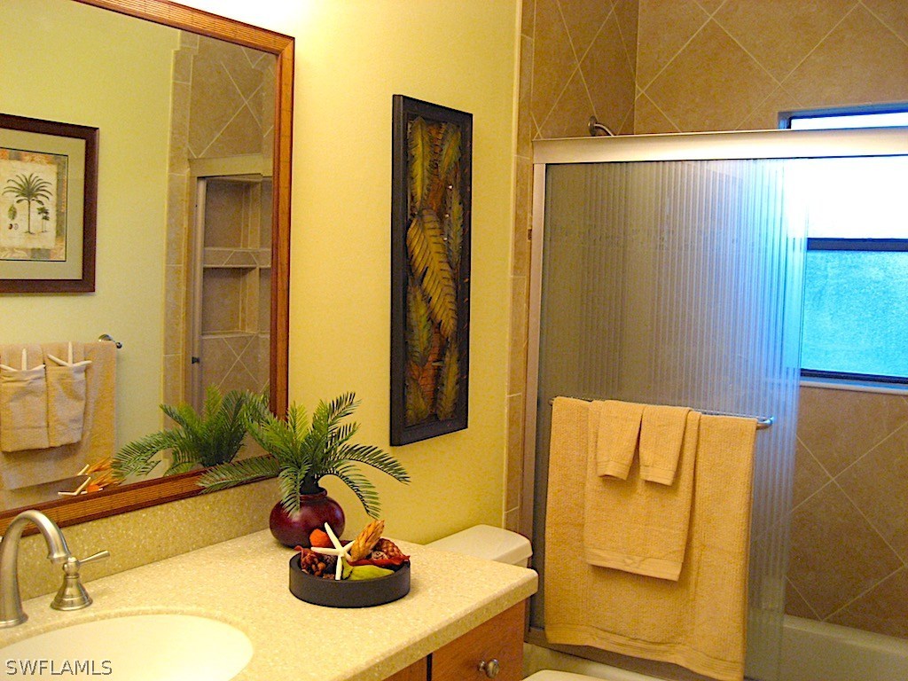 5117 Sea Bell Road, Unit F108 Sanibel, FL 33957 - Photo 8 of 17 a bathroom with a sink and a mirror