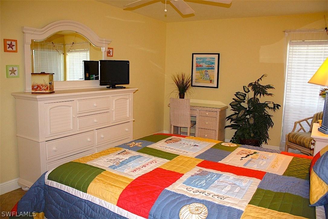 5117 Sea Bell Road, Unit F108 Sanibel, FL 33957 - Photo 9 of 17 a bedroom with a bed and flat screen tv