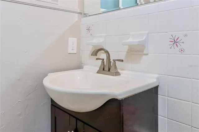 a close view of sink a washer and dryer