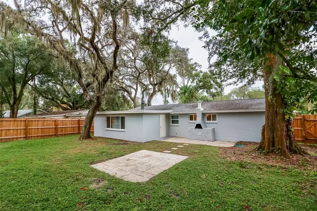a front view of house with yard and trees