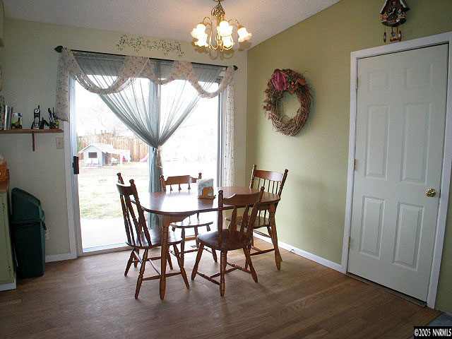 3860 Fulmar Court Reno, NV 89508 - Photo 8 of 9 a view of a dining room with furniture a chandelier and wooden floor