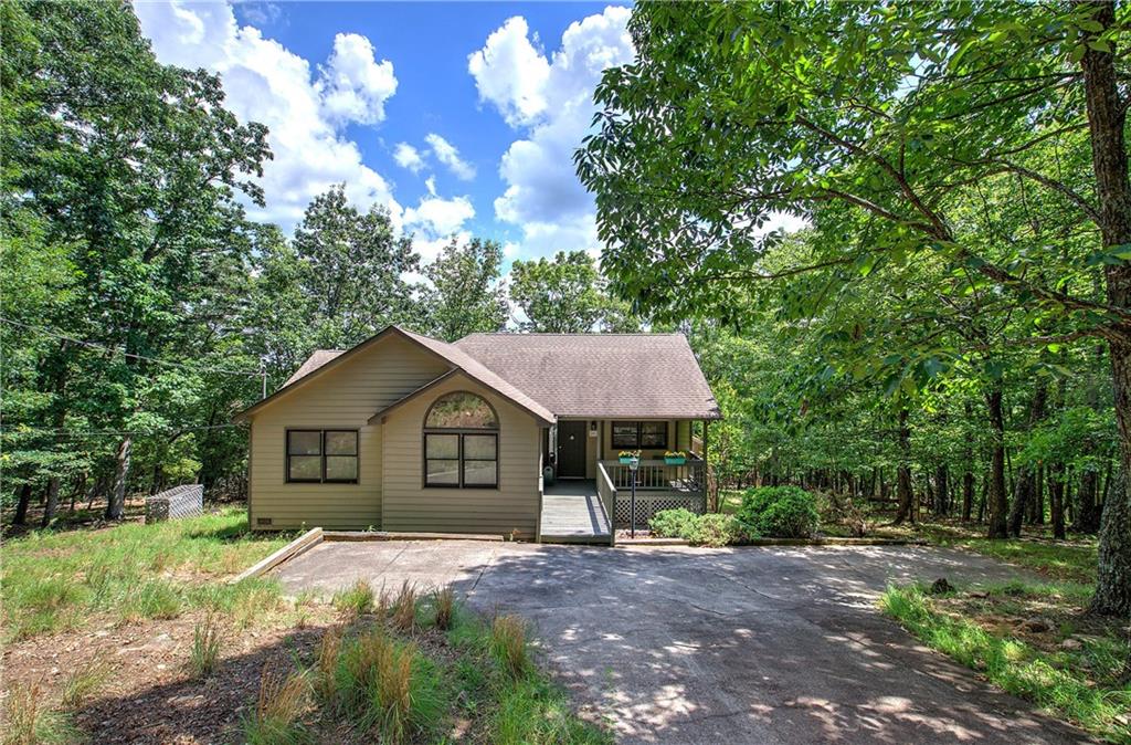 1379 Little Hendricks Mountain Road Jasper, GA 30143 - Photo 2 of 60 a front view of a house with a garden and trees