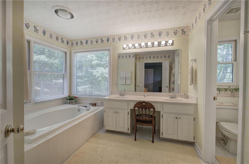 1379 Little Hendricks Mountain Road Jasper, GA 30143 - Photo 23 of 56 a spacious bathroom with a tub sink and mirror