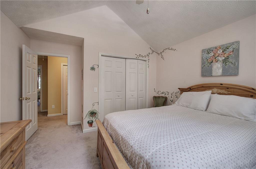 1379 Little Hendricks Mountain Road Jasper, GA 30143 - Photo 28 of 56 a bedroom with a bed and a chandelier