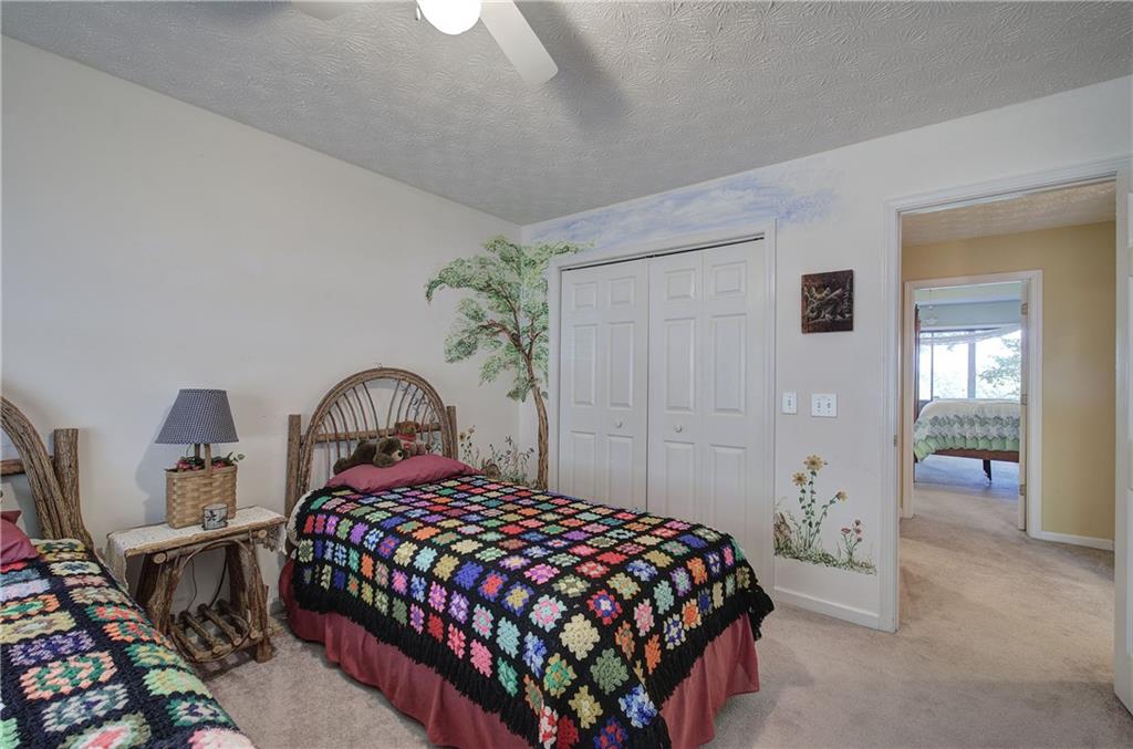 1379 Little Hendricks Mountain Road Jasper, GA 30143 - Photo 31 of 56 a bedroom with a bed and a table