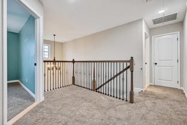 en empty room with windows and ceiling fan