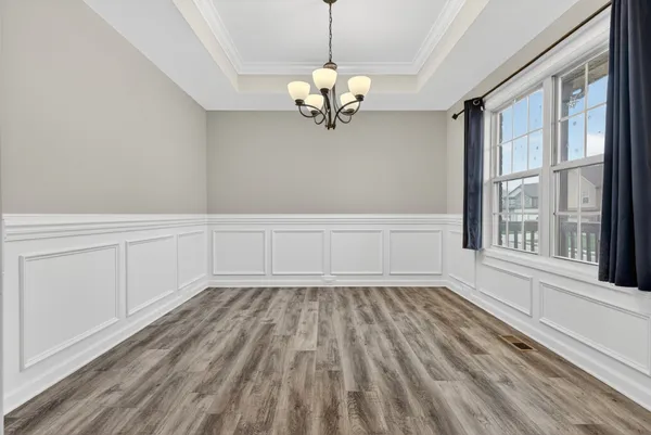 a view of a chandelier fan and wooden floor