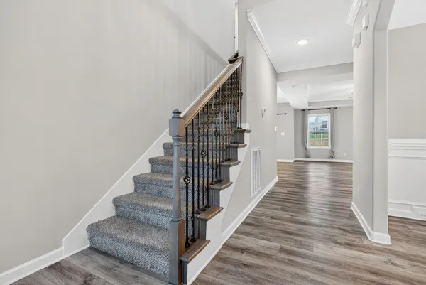 a view of a hallway with wooden floor and entryway