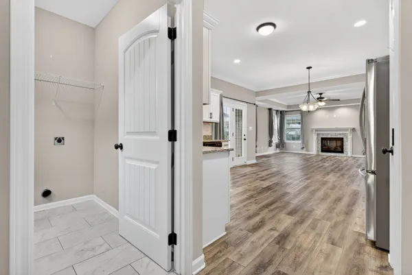 a view of a hallway to a bedroom and a ceiling fan window