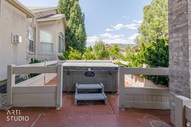 2327 Bluff Ridge Drive Syracuse, UT 84075 - Photo 46 of 66 Outdoor spa with protective fencing situated on a red-toned patio