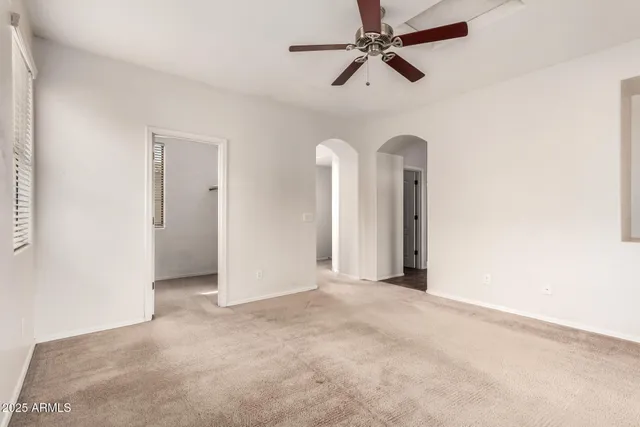 a view of a room with a ceiling fan