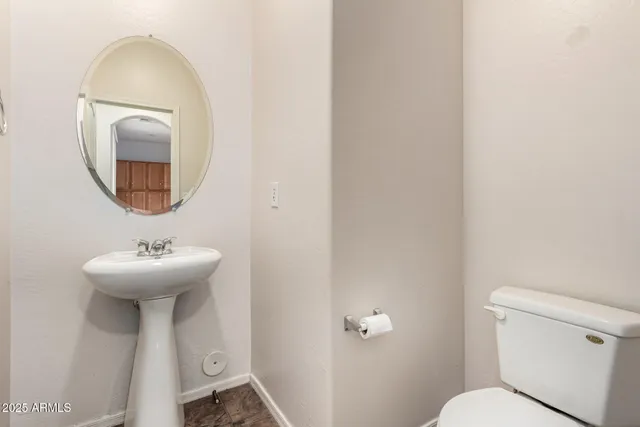 a bathroom with a sink a mirror and a toilet